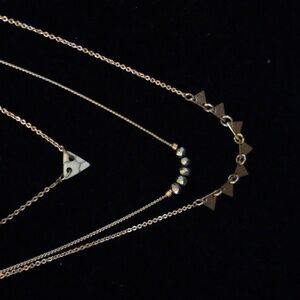 Gold Tone triple layered necklace.